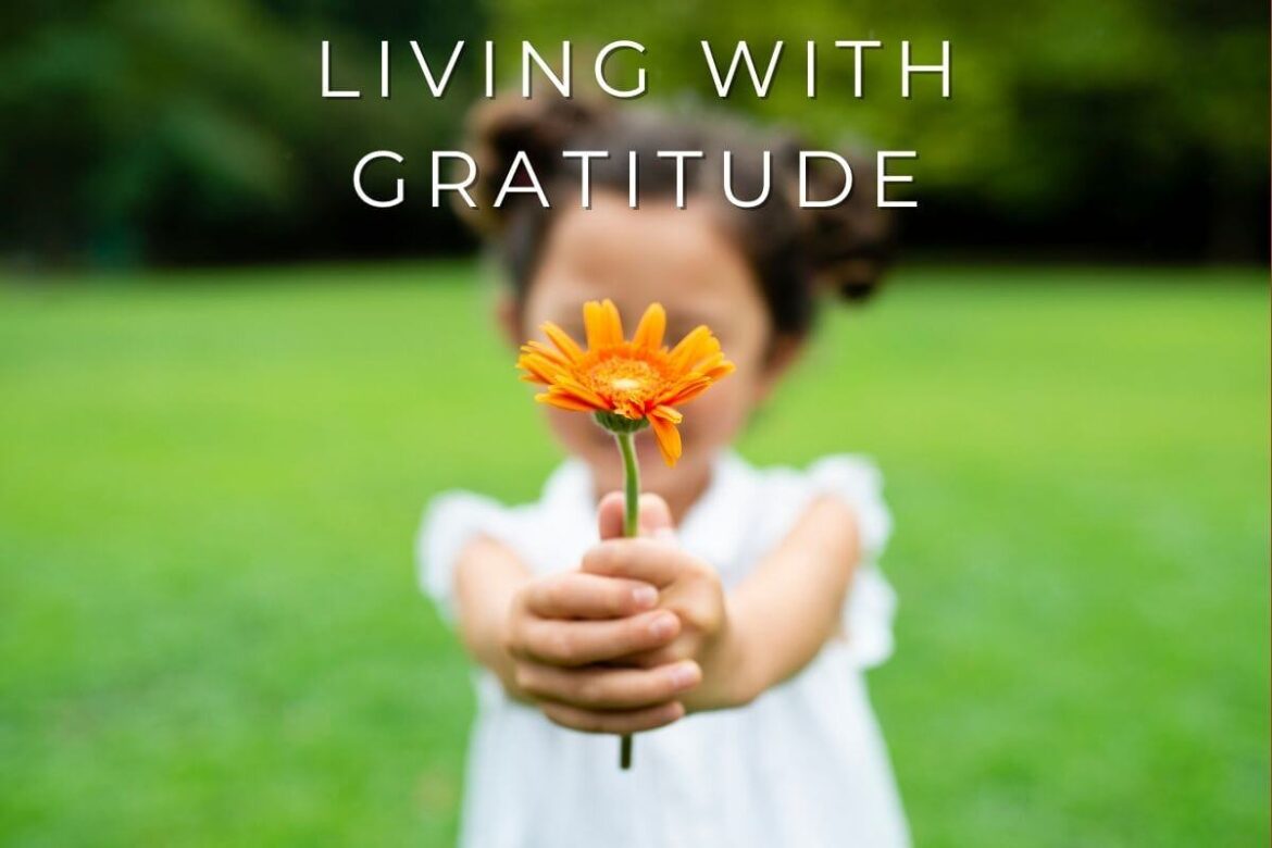 A little girl offering flowers with gratitude