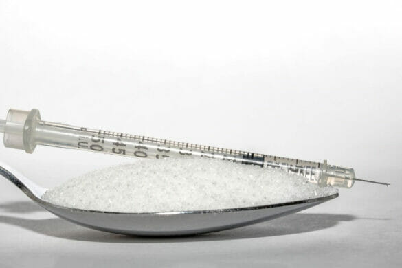 Cover image for effective home remedies for diabetes - Image of a spoonful of sugar and an insulin syringe