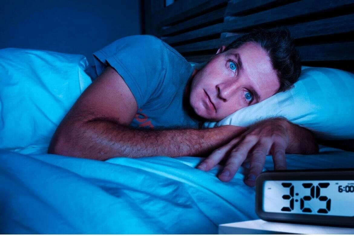 A man awake in the middle of the night due to insomnia