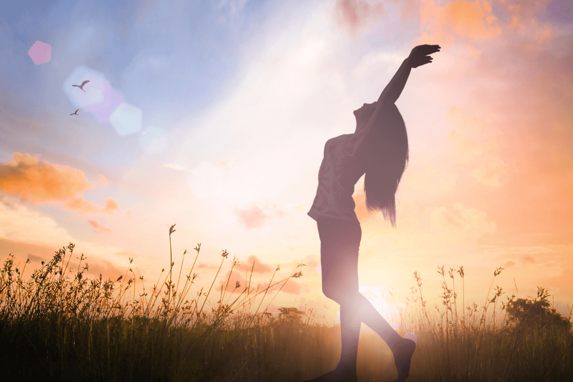 A happy girl at sunrise