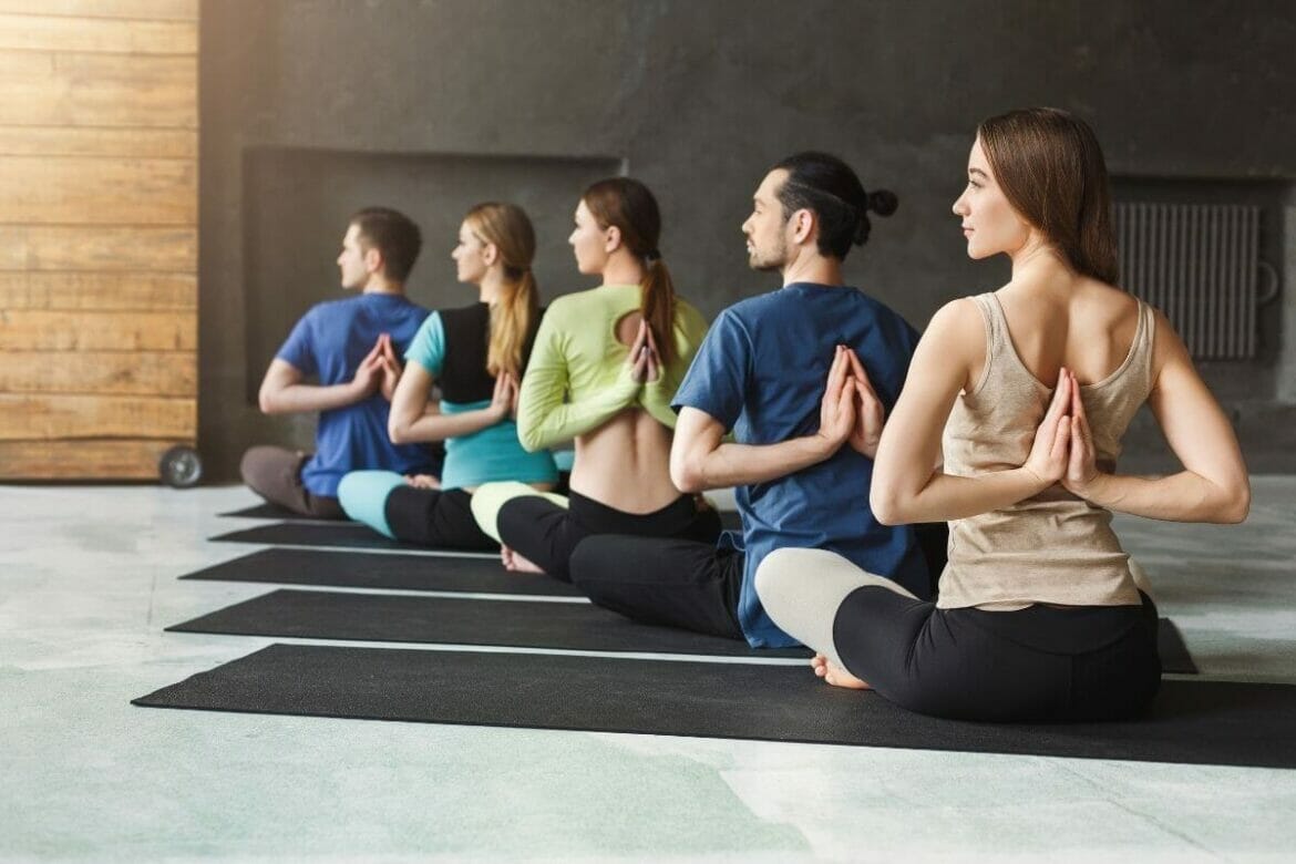 Students practising yoga in a class