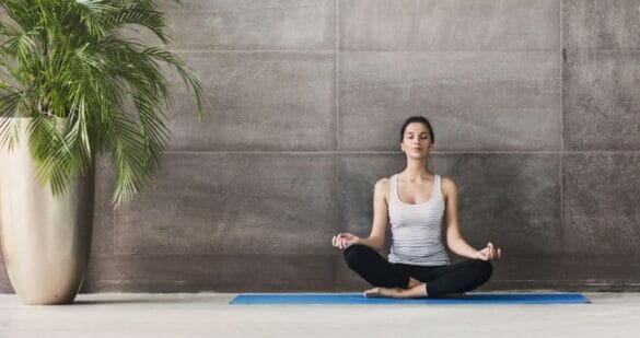 Woman doing meditation in a yoga studio