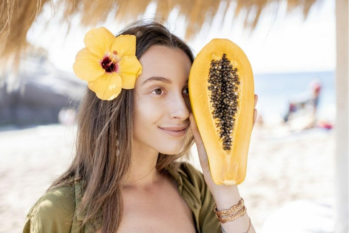 Image of a girl holding half-cut papaya