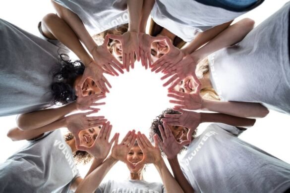 Image of a group of volunteers showing their hands together