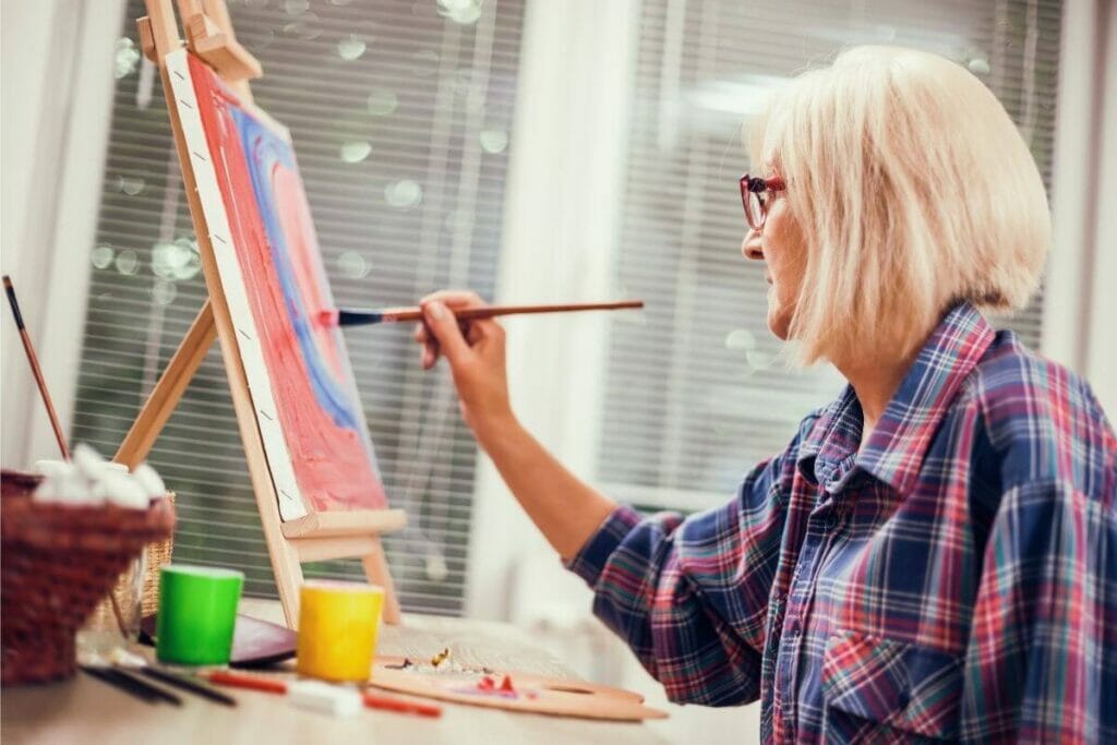 Woman painting on a canvas