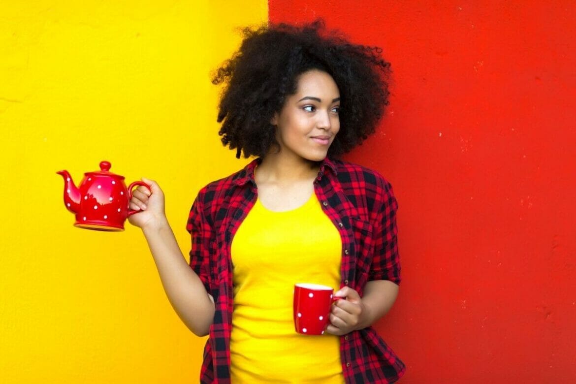Image of a young woman holding teapot and cup