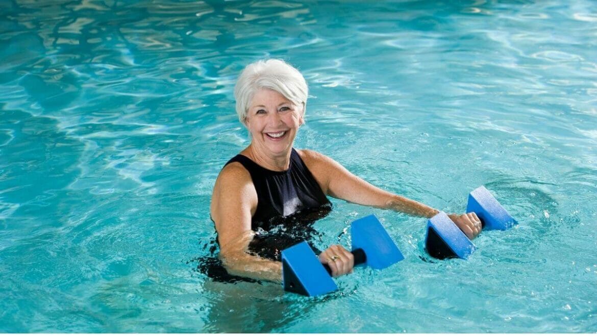 Senior woman practising water aerobics for health benefits
