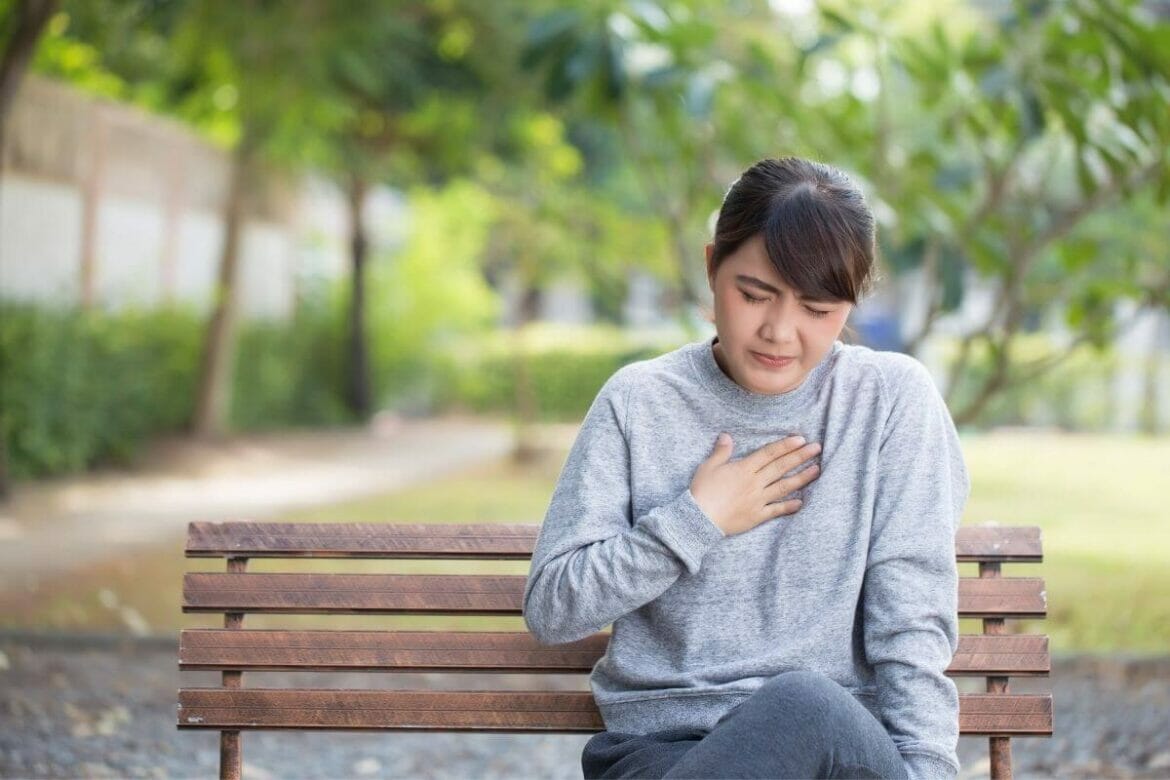 Woman suffering from heartburn