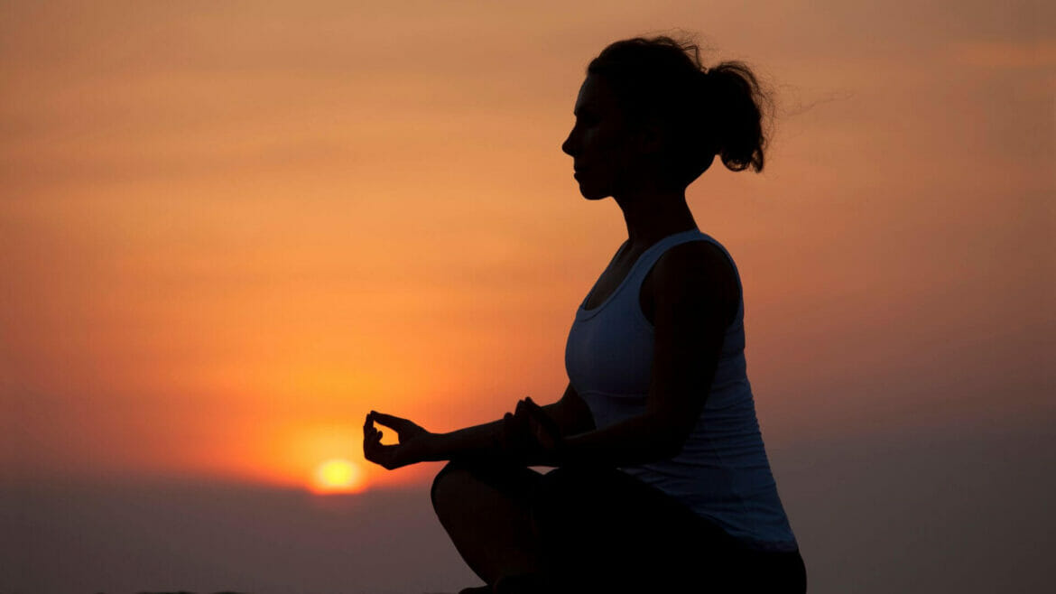 Image of a young woman on meditation, one of the ways to spirituality