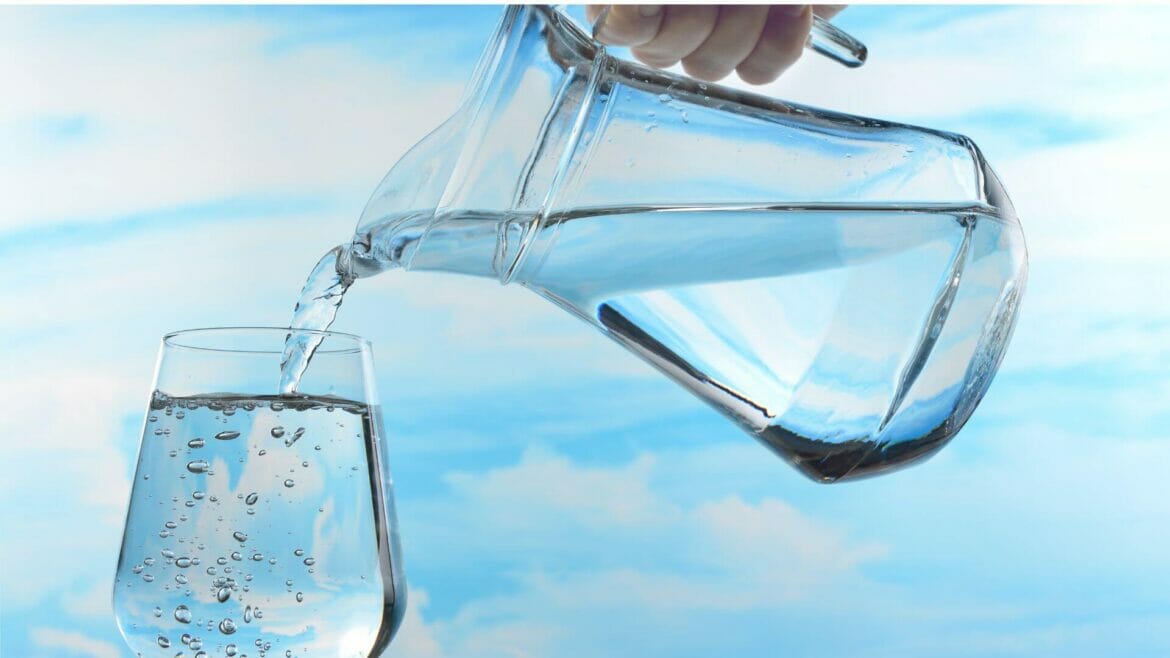 Image of water poured from a jar into a glass