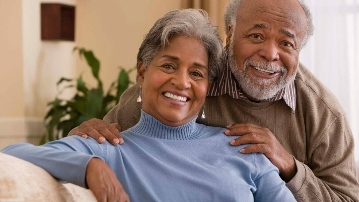 Image of older woman and man smiling without dental problems and good oral health