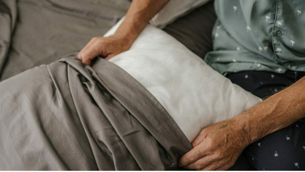Image of a man changing pillowcase
