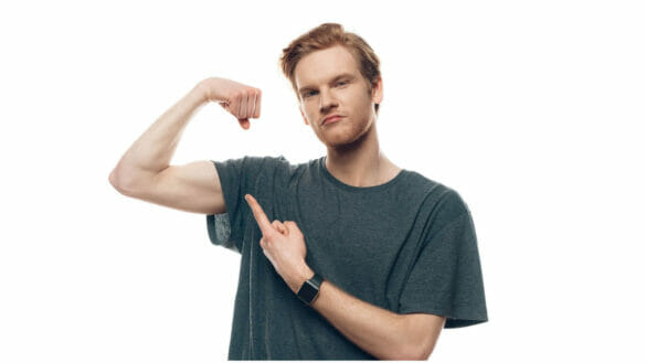 Image of a thin young man showing his biceps - Yoga may help gain weight by improving muscle endurance and muscle mass