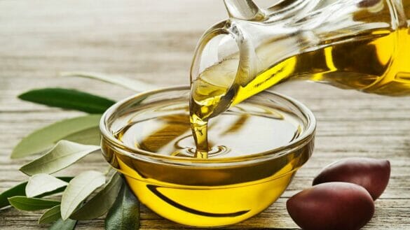 Image of olive oil poured from a bottle into a bowl