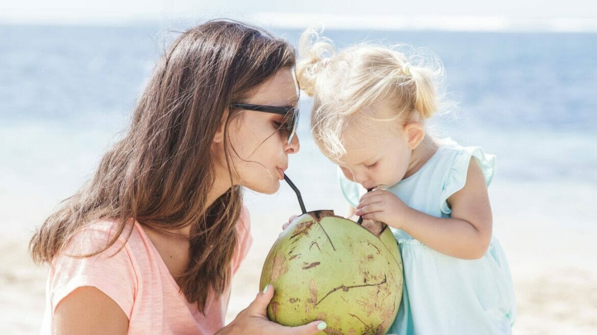 Image of a mother and child drinking coconut water that provides many health benefits