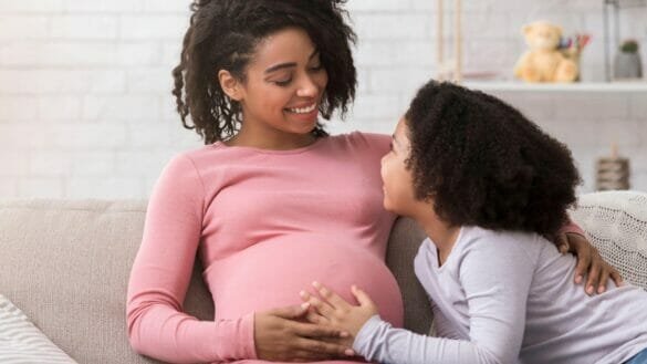 Image of a Mother in the second trimester of pregnancy with her elder child.