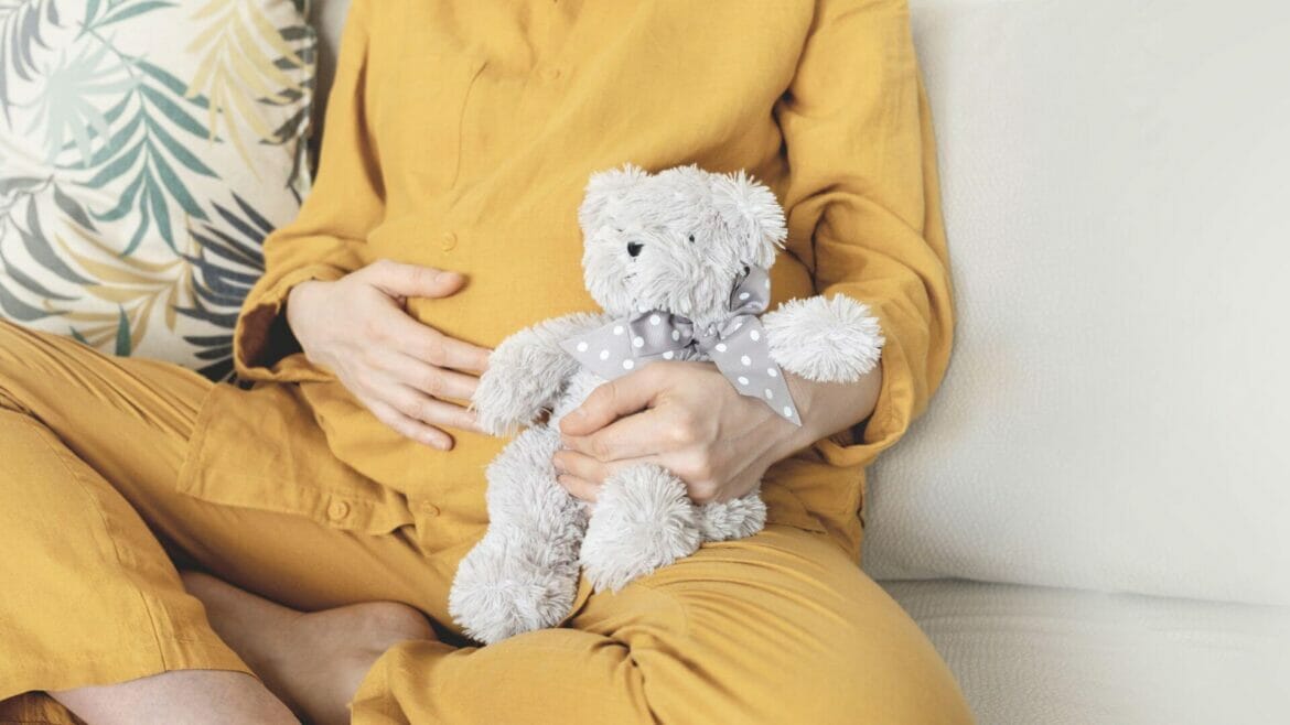 Image of an expectant mother with a teddy