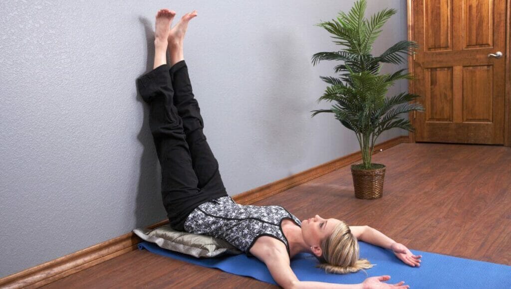 Image of a woman practising legs up the wall pose