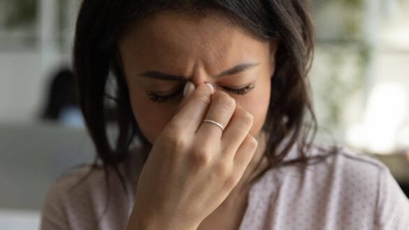 Image of a woman with dry eyes and fatigue - unusual symptoms of rheumatoid arthritis