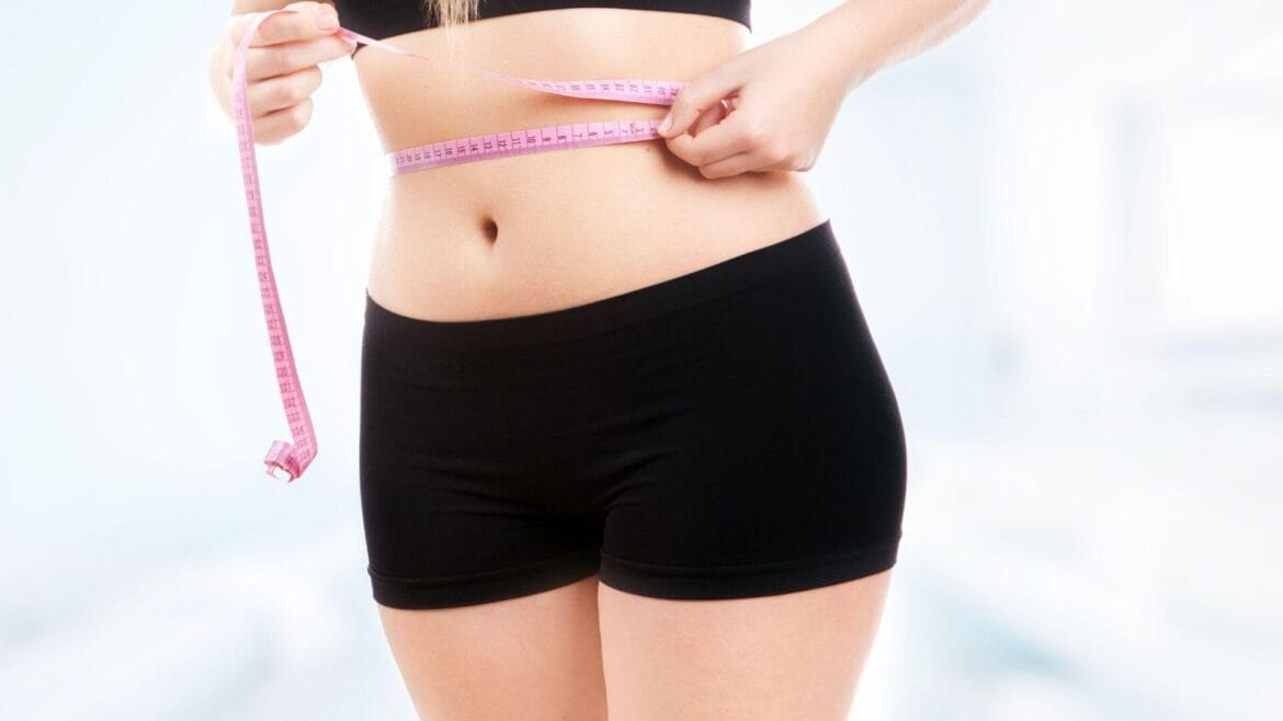 Image of a woman measuring waist-to-hip ratio