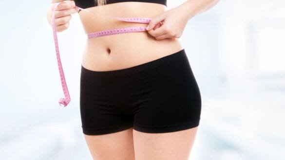 Image of a woman measuring waist-to-hip ratio