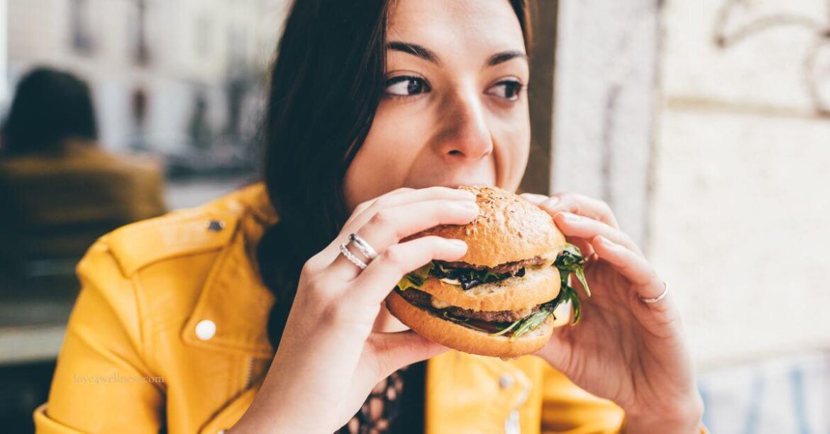 Image of a woman eating and chewing fast that may cause bloating