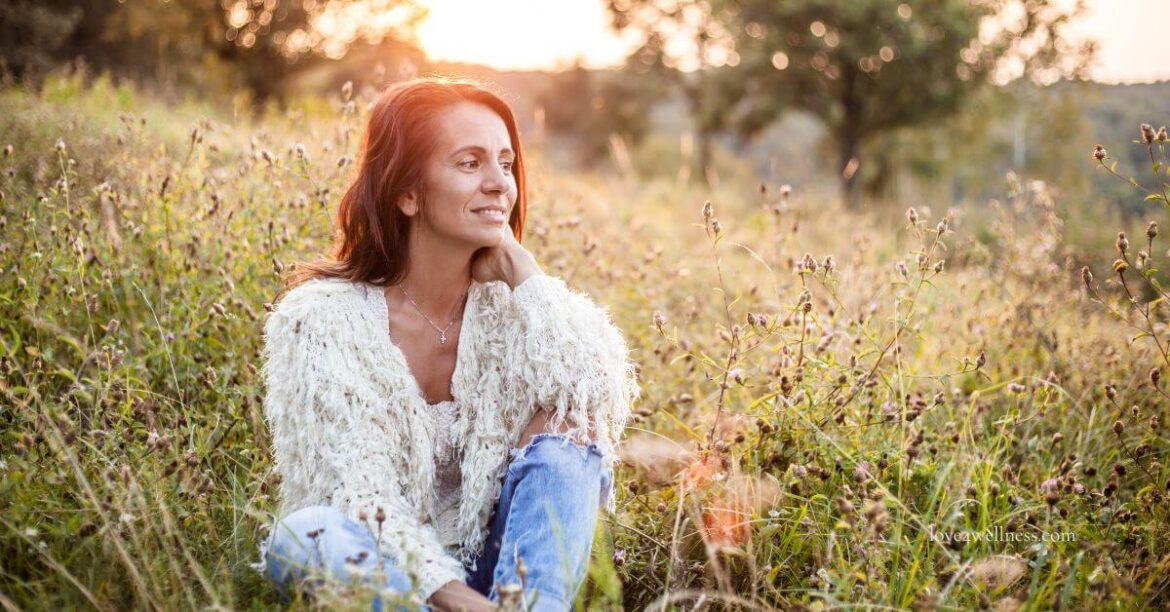 Image of a happy woman of menopause age enjoying nature