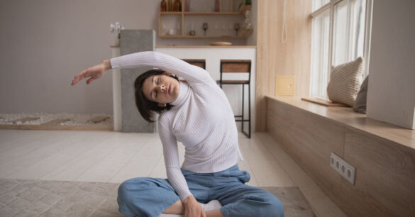 Woman doing stretch exercises to manage menopause stiffness