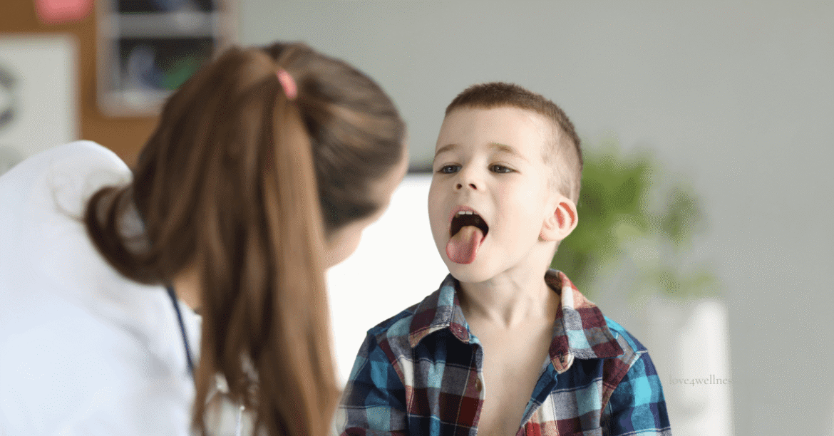 Image of a doctor examining adenoids in a boy child