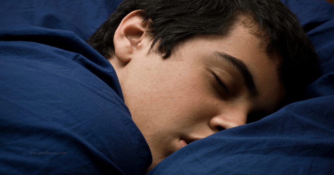 Image of a teenager sleeping on bed