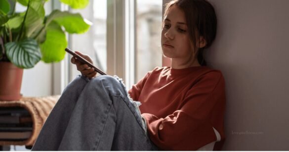 A school-going child showing signs of anxiety, sitting quietly by a window