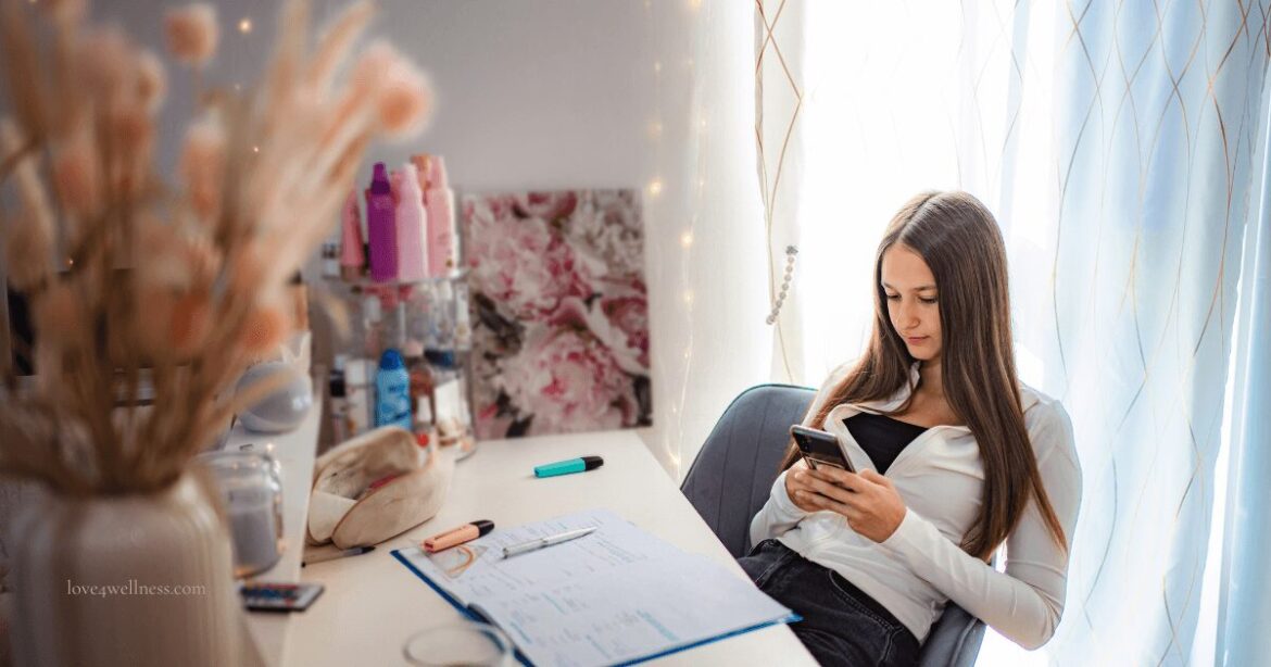 Teenager Procrastination - Image of a teenage girl staring at mobile, procrastinating work