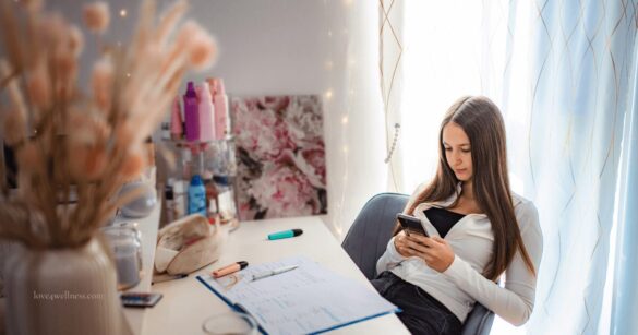 Teenager Procrastination - Image of a teenage girl staring at mobile, procrastinating work